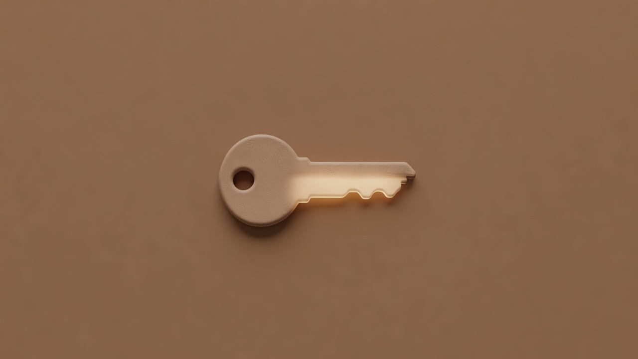 Matte clay-style key render glowing faintly amber against a plain brown background