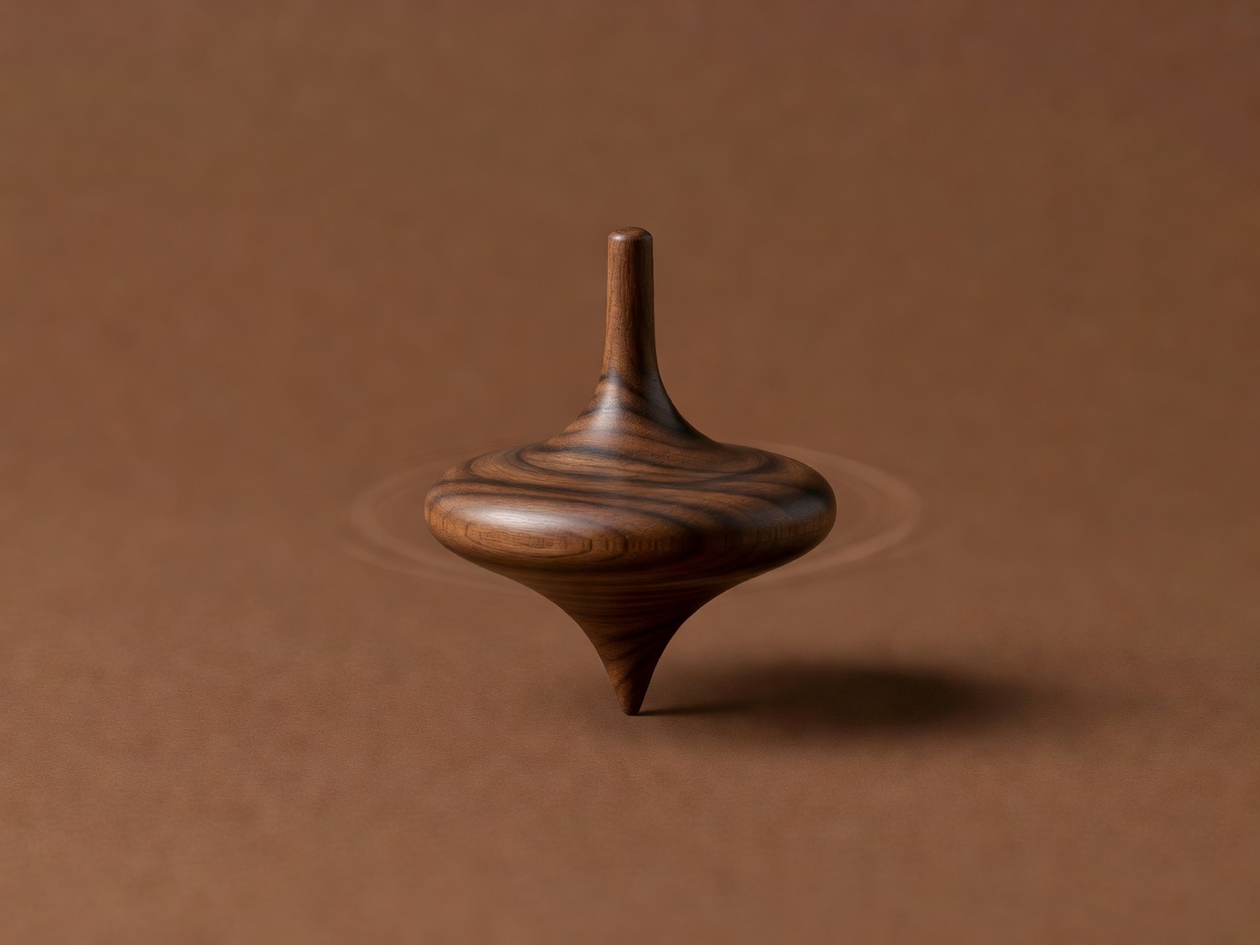 Wooden spinning top on its point against a plain brown backdrop